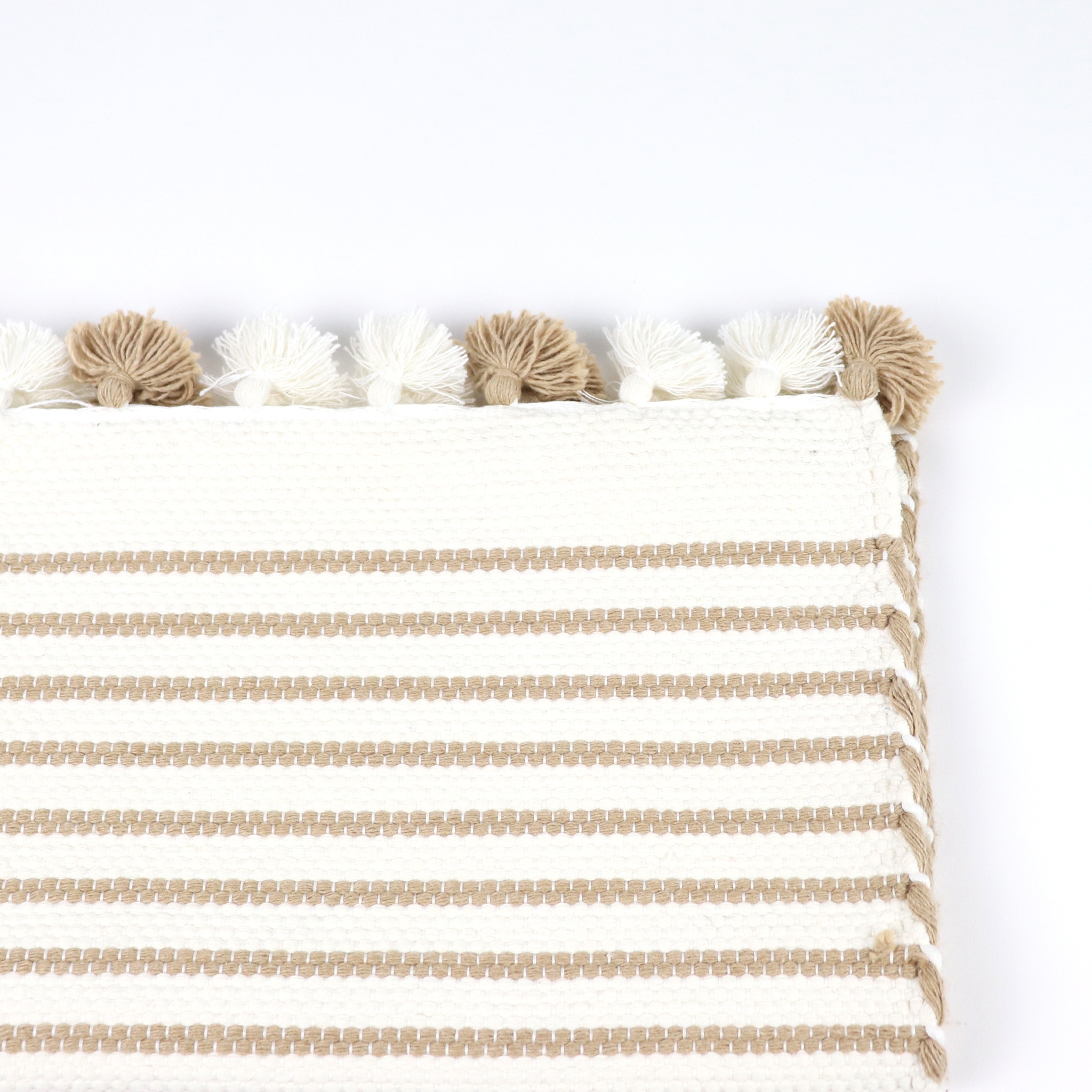 Beige and white mat with poms